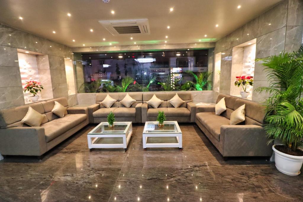 a large living room with couches and tables at Clarks Inn Express Udaipur in Udaipur