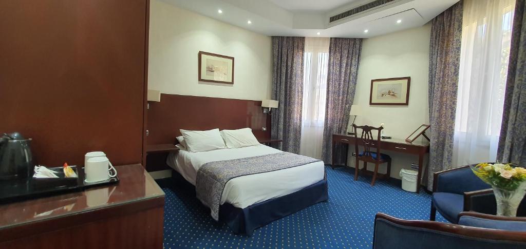 a hotel room with a bed and a desk at Horus House Hotel Zamalek in Cairo