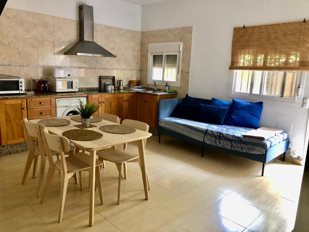 a kitchen and living room with a table and a couch at Casa a 65 metros de la Playa in El Palmar