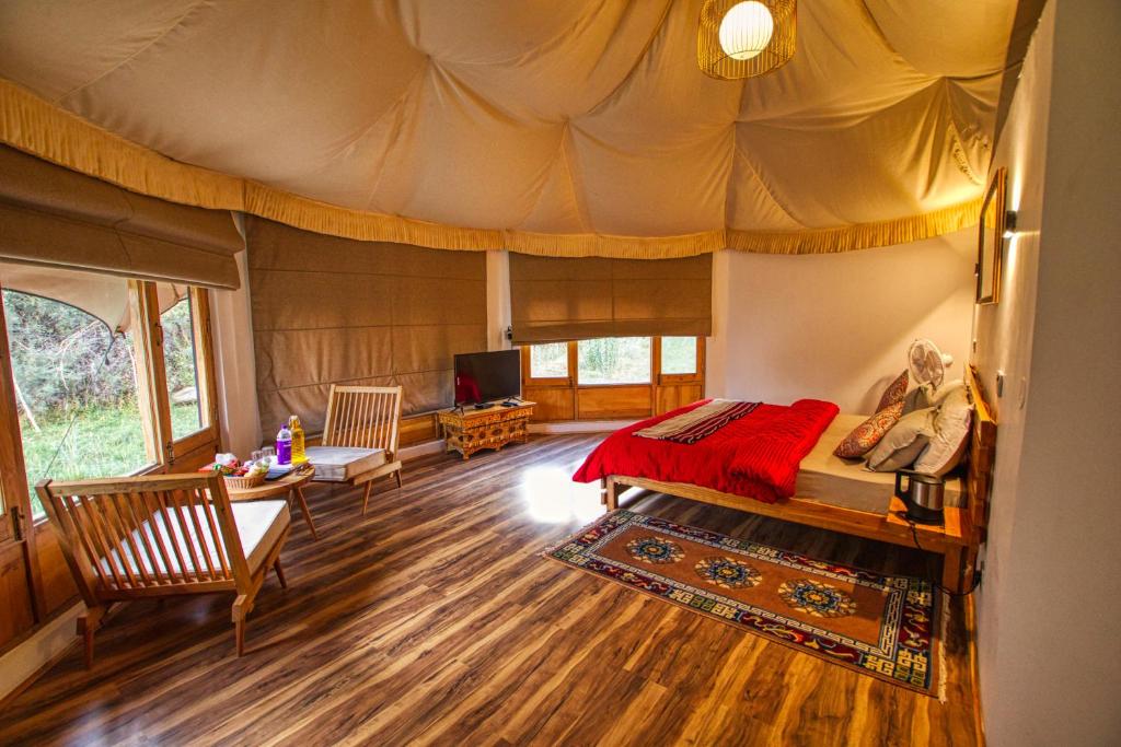 a bedroom with a bed in a tent at Chalet Seabuckthorn - Hunder in Hundar