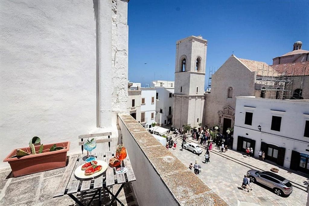 a view of a city from a balcony of a building at Dei Serafini in Polignano a Mare