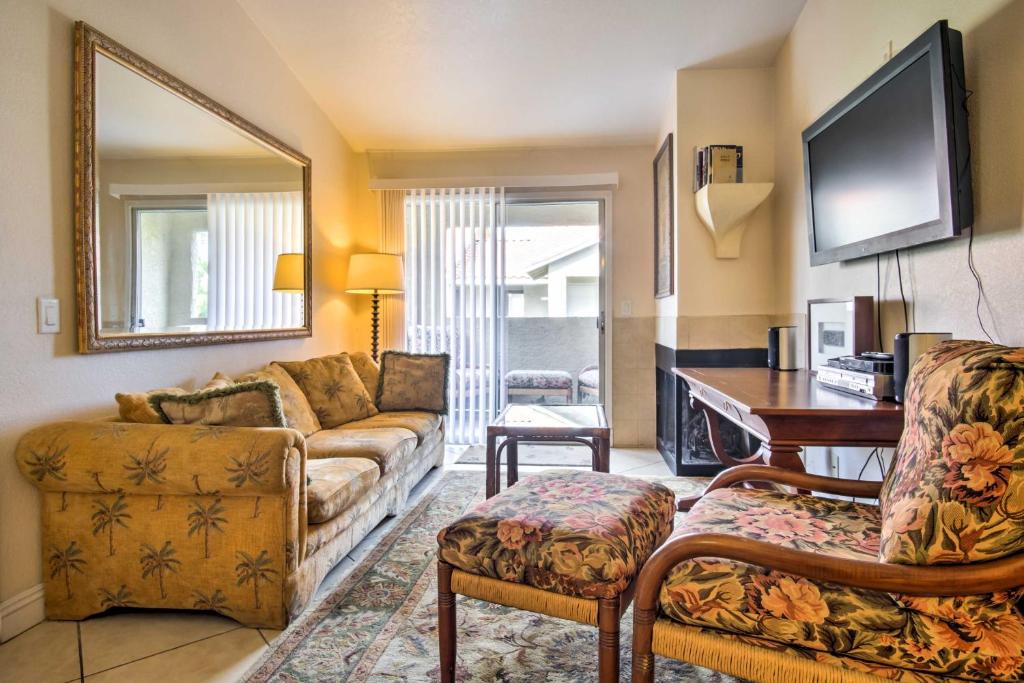 a living room with a couch and a table and a tv at Pet-Friendly Las Vegas Condo 1 Mi to the Strip! in Las Vegas