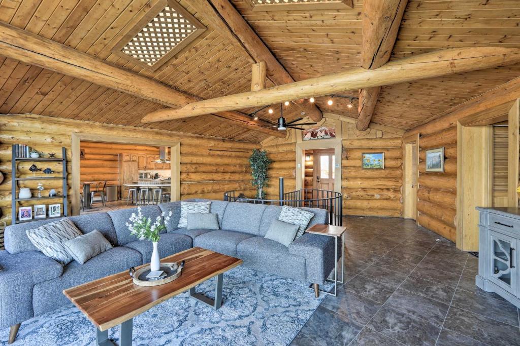 a living room with a couch and a table at Fairbanks Log Cabin with Waterfront Deck and Views! in Fairbanks