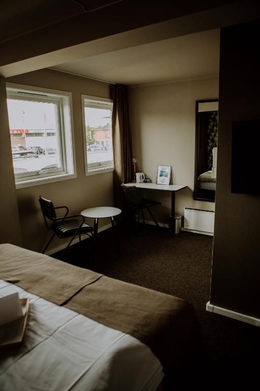 Postel nebo postele na pokoji v ubytování Bakkalandet Hotel