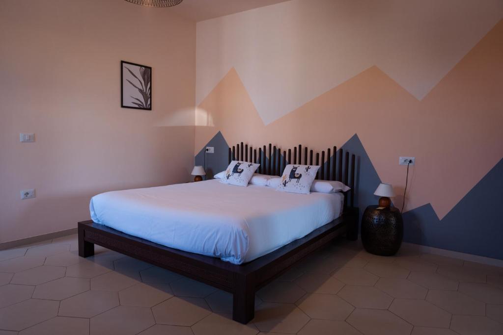 a bedroom with a large bed in a room at Ca' del Viaggiatore in Farigliano
