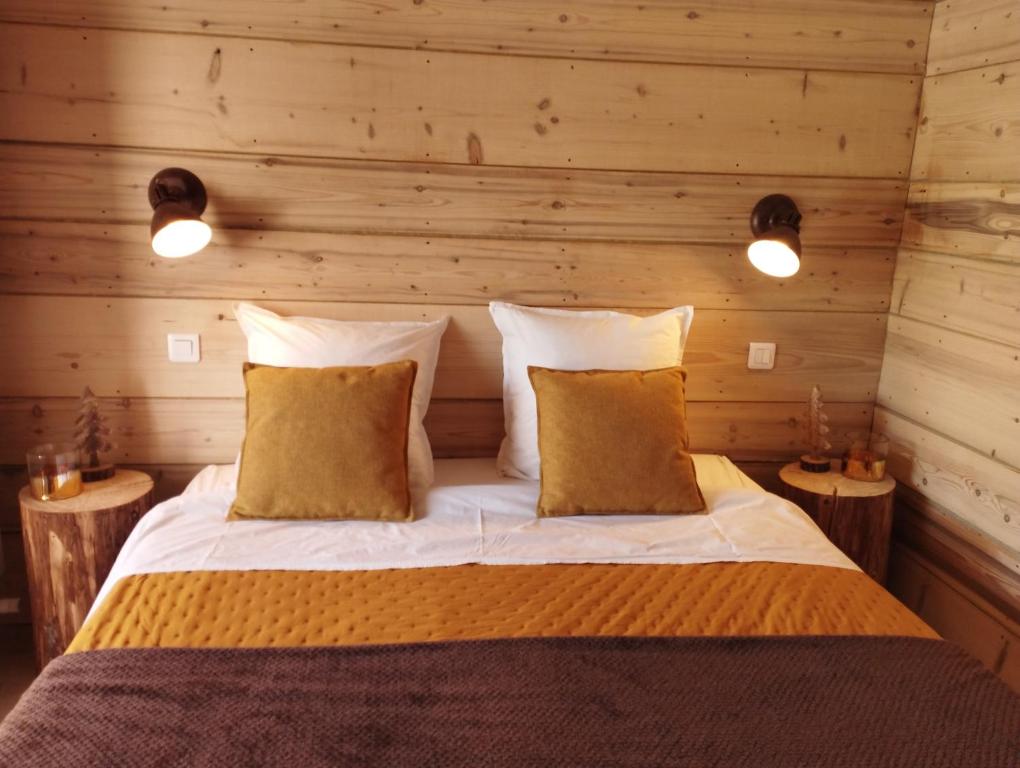a bedroom with a bed in a wooden wall at Au charmant chablis in Champagnole