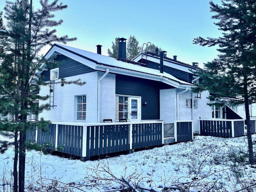 una casa blanca con una cerca en la nieve en Levin Keskusta, Kätkäläinen B3 ja D1 en Levi