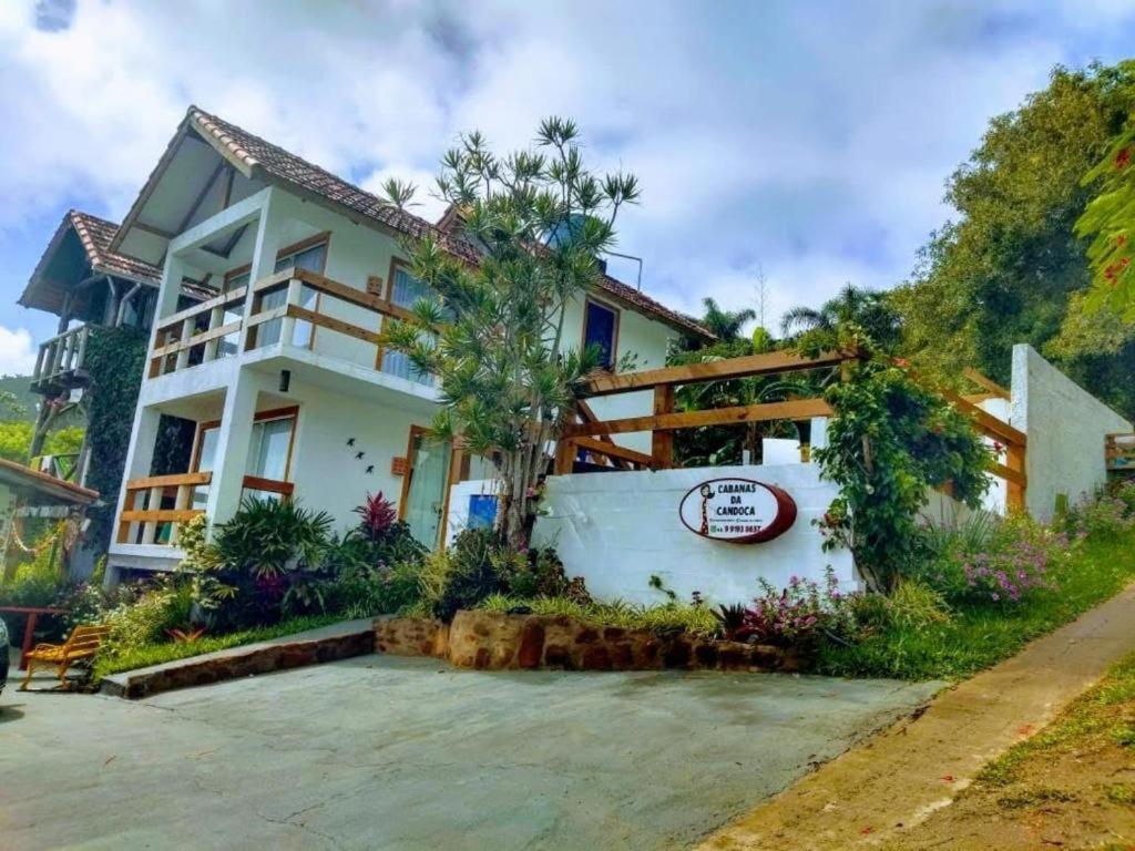 a house with a sign in front of it at Mediterrâneo Flat Praia da Gamboa- Cabanas da Candoca in Garopaba