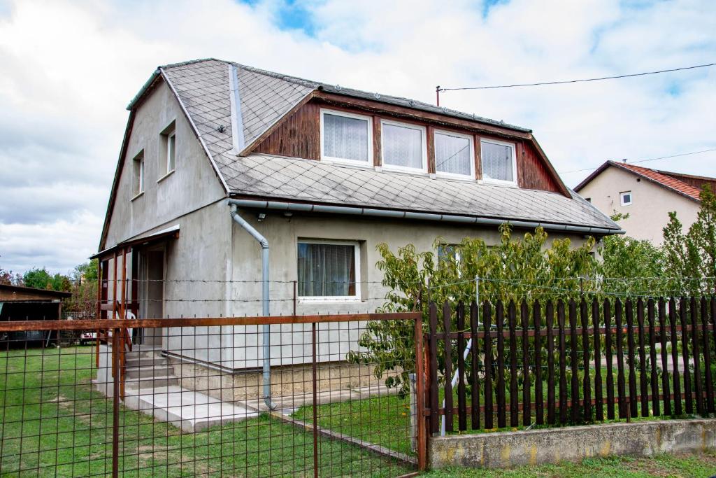 a house with a fence in front of it at Luca Apartman in Esztergom