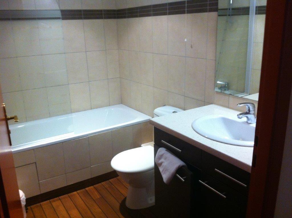 a bathroom with a tub and a toilet and a sink at Résidence du Soleil in Lourdes