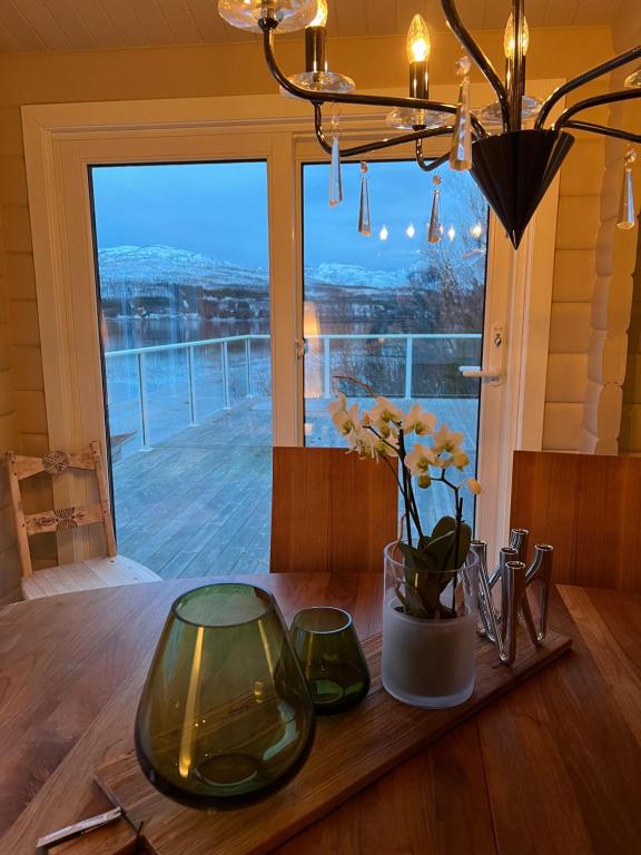 a dining room table with a view of a window at Håkøyveien 151, Tromsø in Tromsø