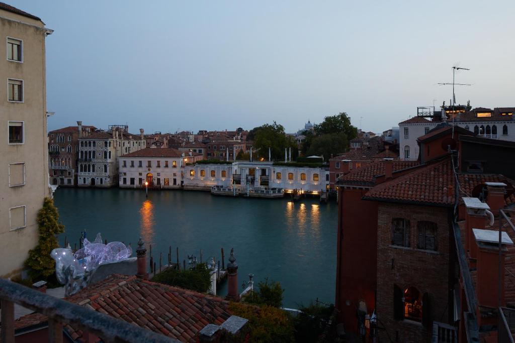 a view of a river in a city with buildings at Hotel Dei Dragomanni in Venice