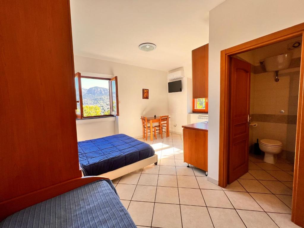 Postel nebo postele na pokoji v ubytování B&b L' Arancio in fiore