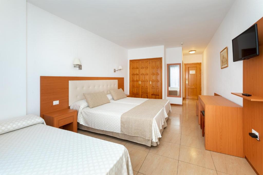 Postel nebo postele na pokoji v ubytování Hotel Don Manolito