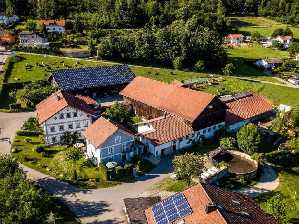 an aerial view of a house with solar panels on it at Ferienbauernhof Rosenberger in Hauzenberg