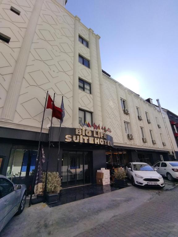 a building with cars parked in front of it at biglife hotel in Istanbul