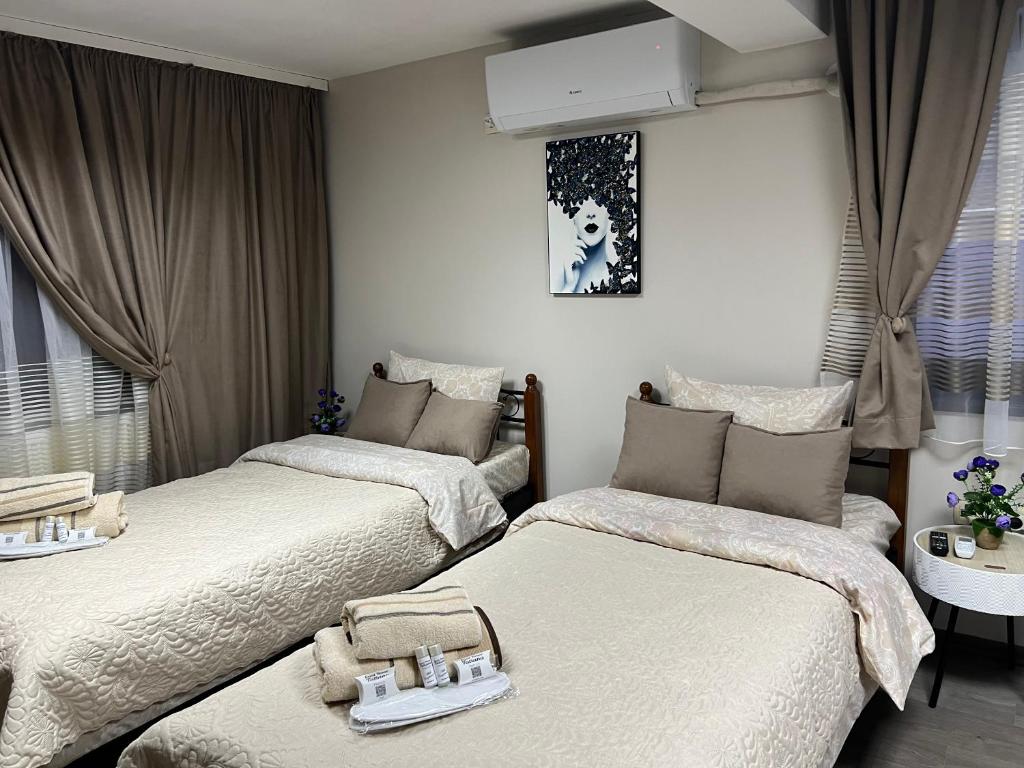 um quarto com duas camas com bandejas em Guest House Tatiana Studio em Petrich