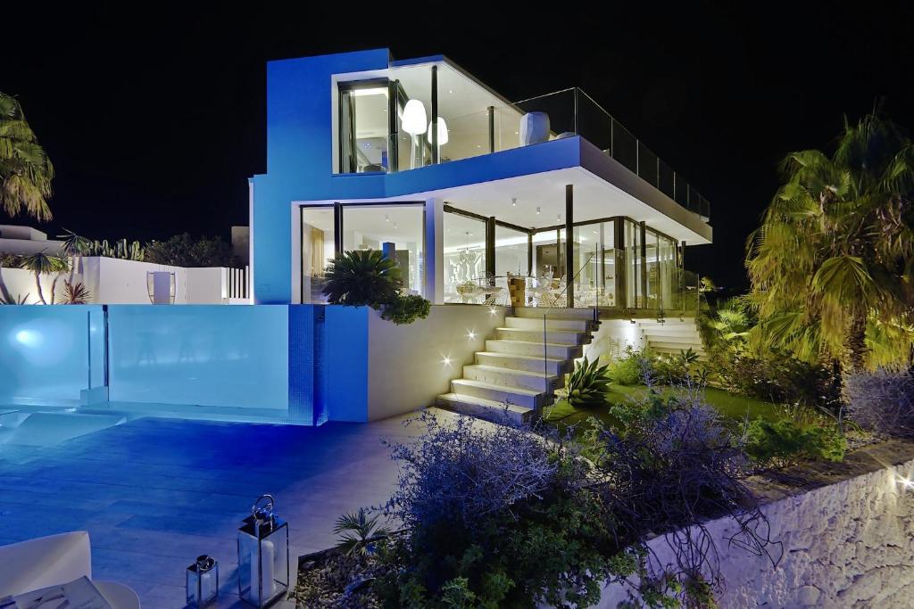 a house with a blue facade at night at Irresistible Ibiza Villa 3 Bedrooms Villa Buena Private Heated Pool & Underfloor Heating San Jose in Sant Josep de sa Talaia