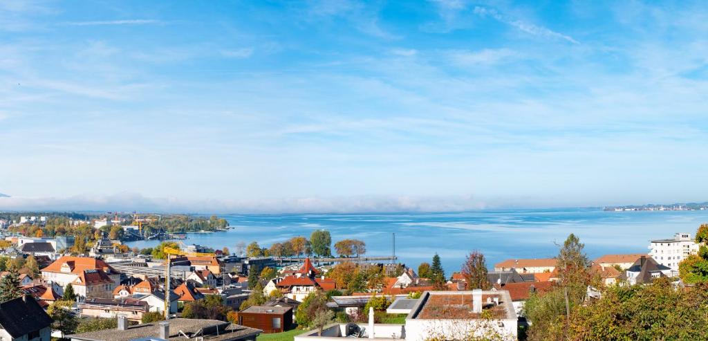 a small town with a view of the water at Haus4Zimmer - Luxus mit Blick über den Bodensee - mit Garage in Bregenz