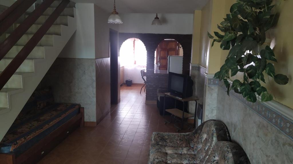 a hallway with a staircase and a living room at Casa de vacaciones Faro 1 in Mar del Plata