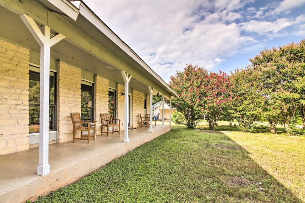 a porch of a house with chairs and tables at Bright Jonestown Retreat with Yard and Porch! in Jonestown