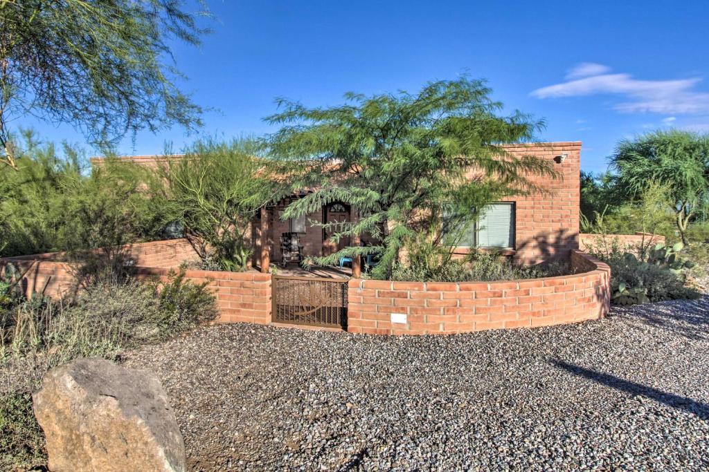 a brick house with a fence in a yard at Tucson Home - Hiking Trail Access On-Site! in Avra