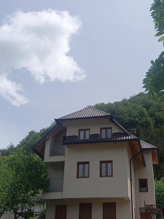 a house with a roof on top of it at Apartmani Jelenača in Sinanovići