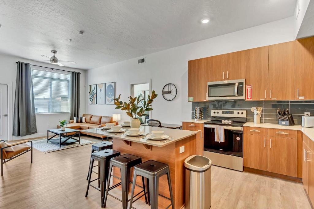 a kitchen with wooden cabinets and a table and chairs at Stunning Corporate Housing Near Hill AFB and DCC in Clearfield