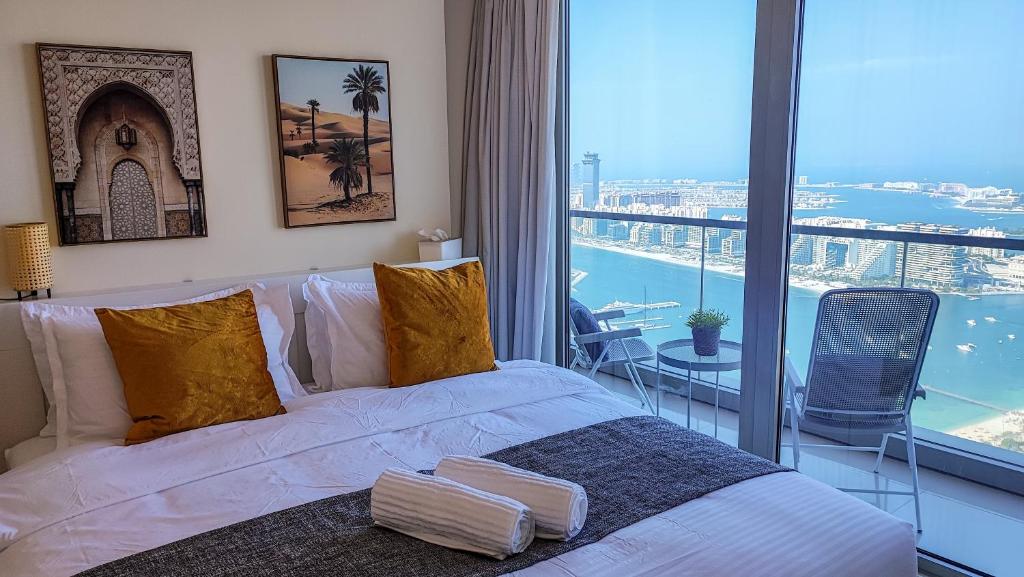 a bedroom with a bed and a view of the ocean at Exquisite, luxe 1BD Apartment, Unparalleled Sea Views, Prime Dubai Marina Location & Full Kitchen by "La Buena Vida Holiday Homes in Dubai