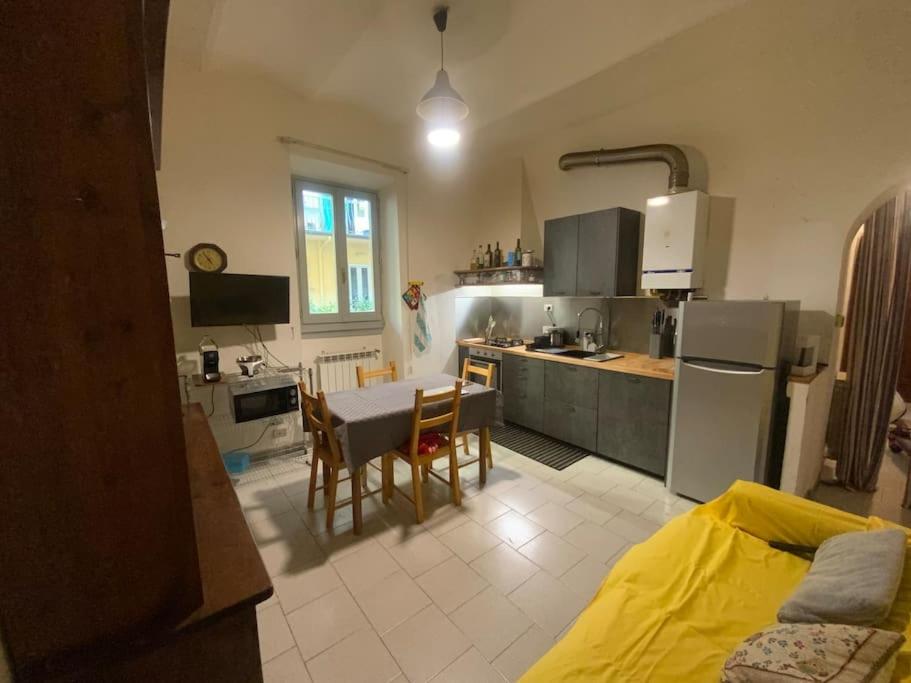a kitchen and dining room with a table and a kitchen with at Double Accomodation In San Frediano in Florence