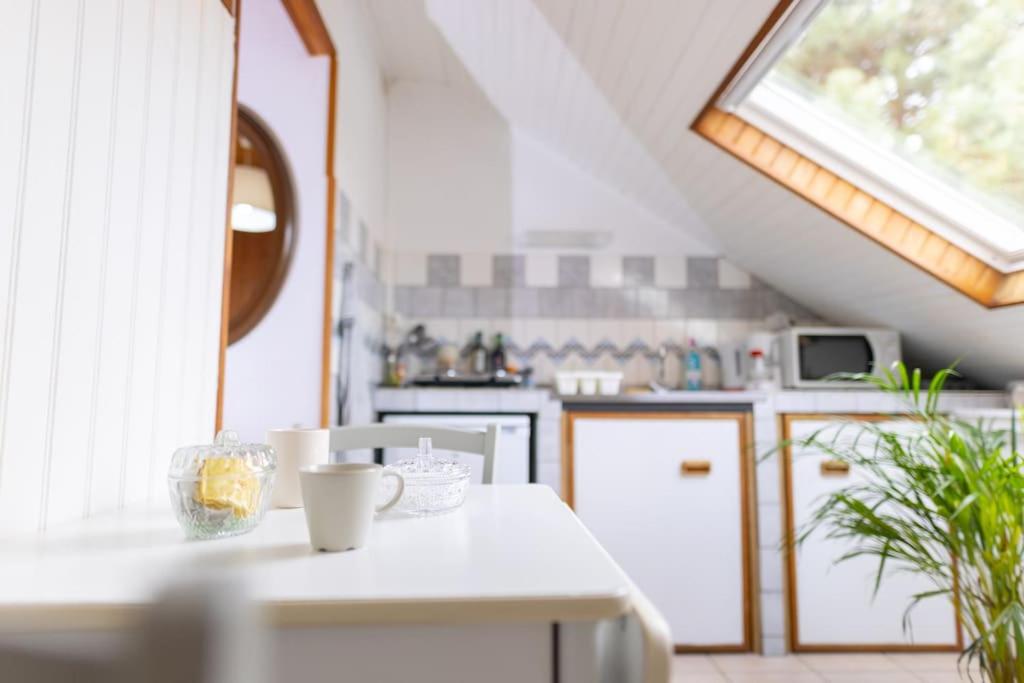 a kitchen with a white counter and a window at Studio sous les étoiles au coeur de Jaurès in Belfort