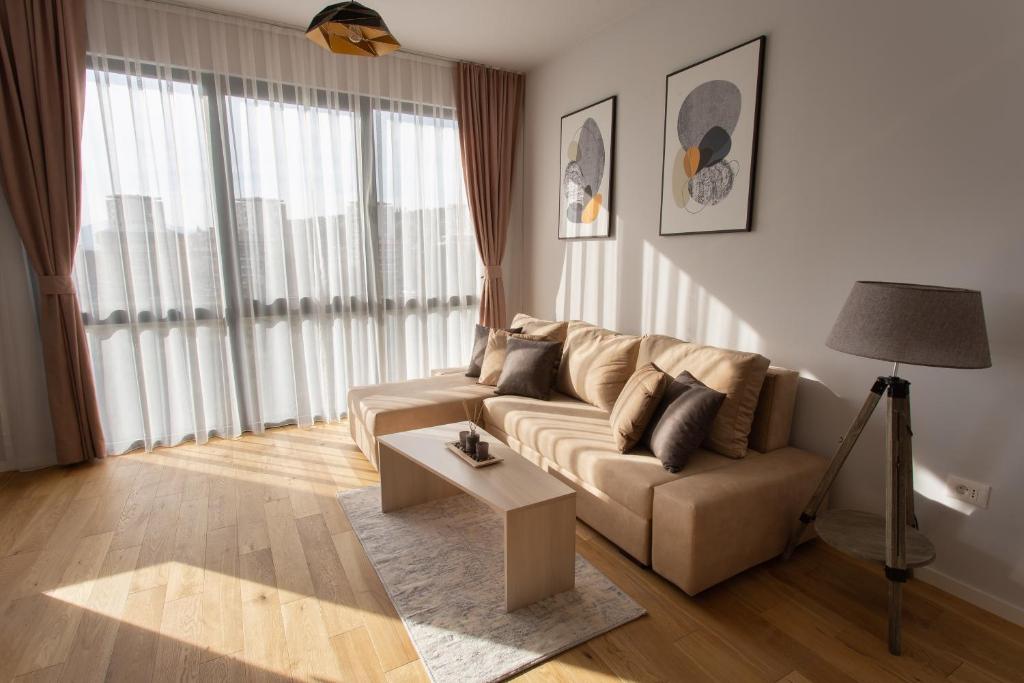 a living room with a couch and a table at LINA - PG, Riverside Apartment in Podgorica