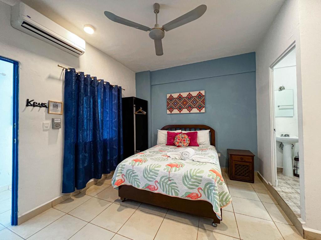 - une chambre avec un lit et un ventilateur de plafond dans l'établissement Studios at Main Park Cozumel, à Cozumel