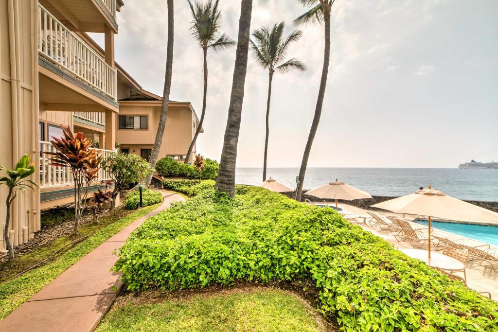a resort with a swimming pool next to the ocean at Oceanfront Kailua-Kona Townhome with Pool and Views! in Kailua-Kona