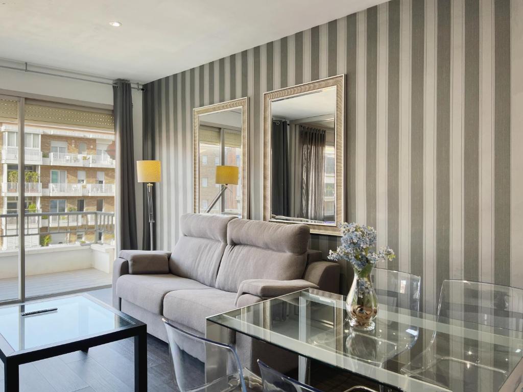 a living room with a couch and a glass table at Stay U-nique Apartments Beltrán i Rózpide in Barcelona