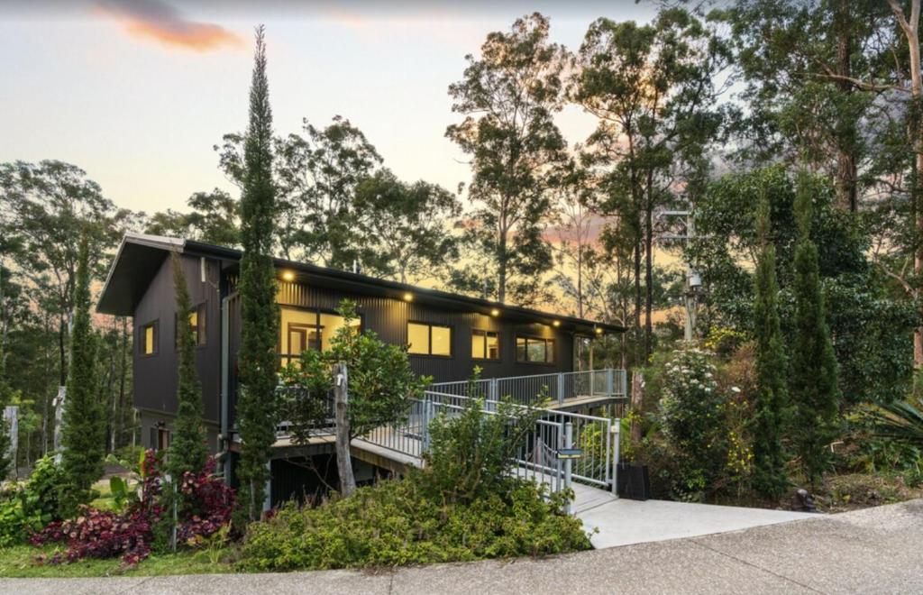 a house in the middle of a forest at Gold Coast Tree Houses in Neranwood