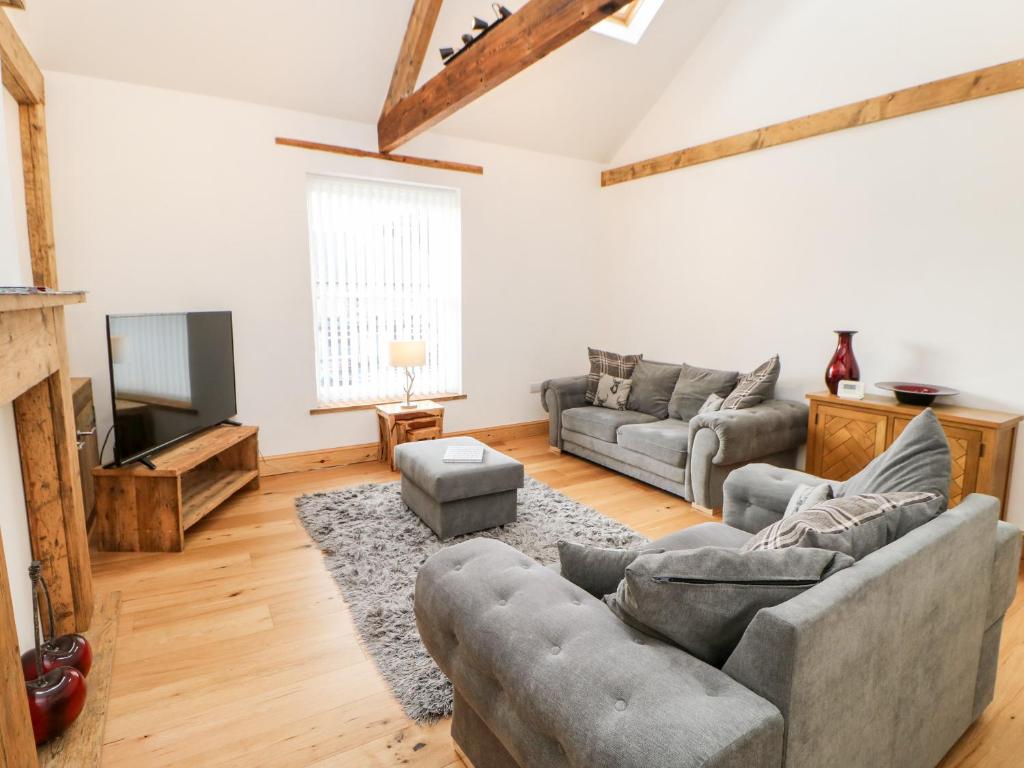 a living room with two couches and a television at Flat Above 27 in Bishop Auckland