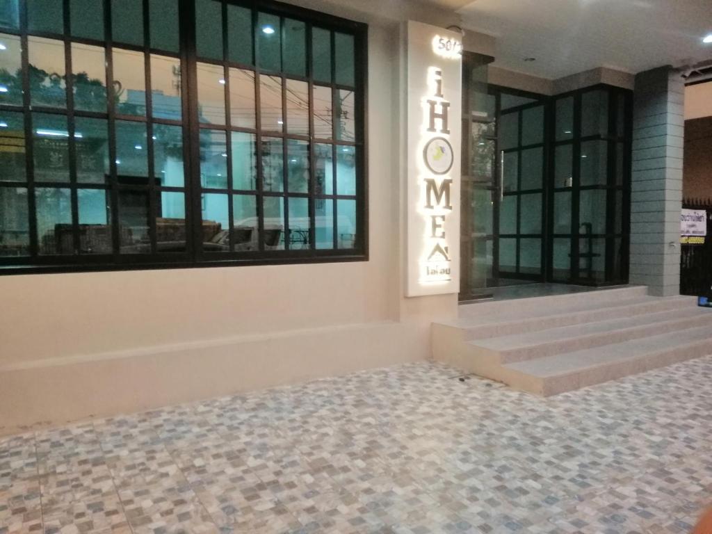 a lobby of a building with stairs and windows at IHome Hostel Hatyai in Songkhla