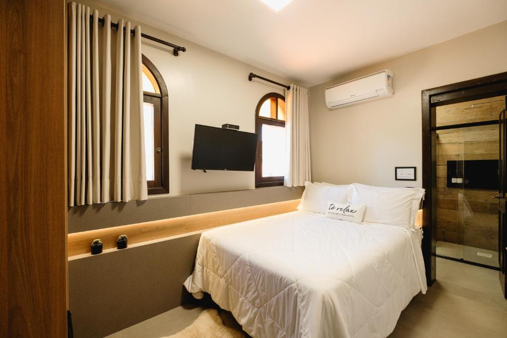 Postel nebo postele na pokoji v ubytování Malbec Casa Hotel