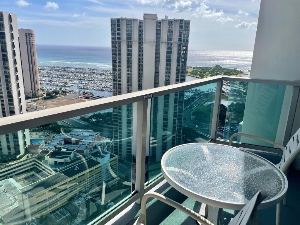 a balcony with a table and a view of the city at Ala Moana Hotel 31st floor in Honolulu