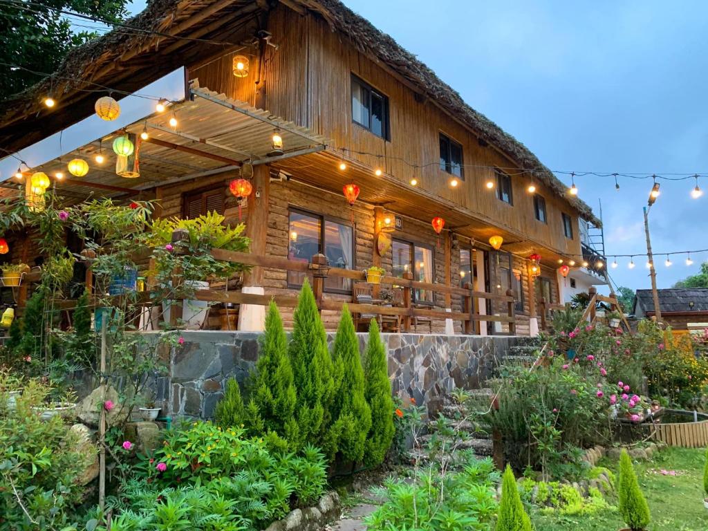 a large wooden house with lights on it at Homestay số 91-Suối Hồ Sa Pa in Sapa