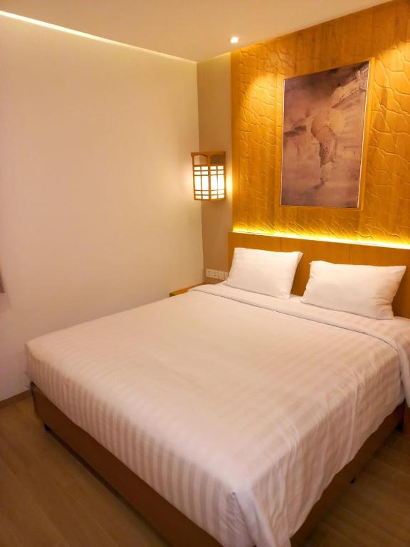 Letto o letti in una camera di UNUMA HOTEL