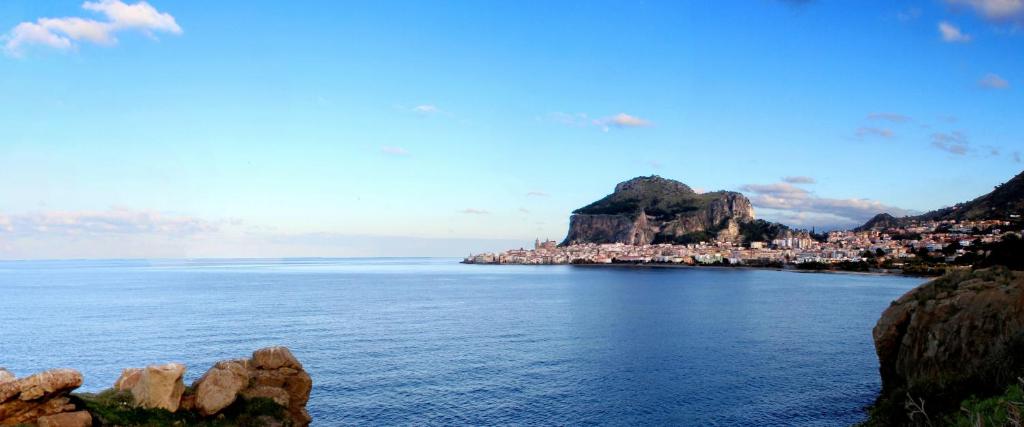a large body of water with a town on a hill at Dolce Risveglio in Cefalù