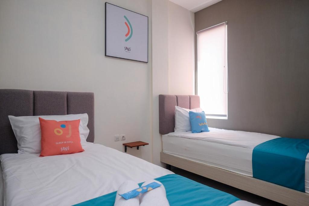 Postel nebo postele na pokoji v ubytování Sans Hotel Fourth Loft Solo