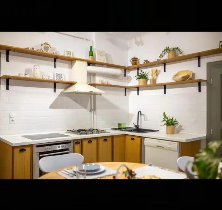 a kitchen with a sink and a stove top oven at Petersen in Sibiu