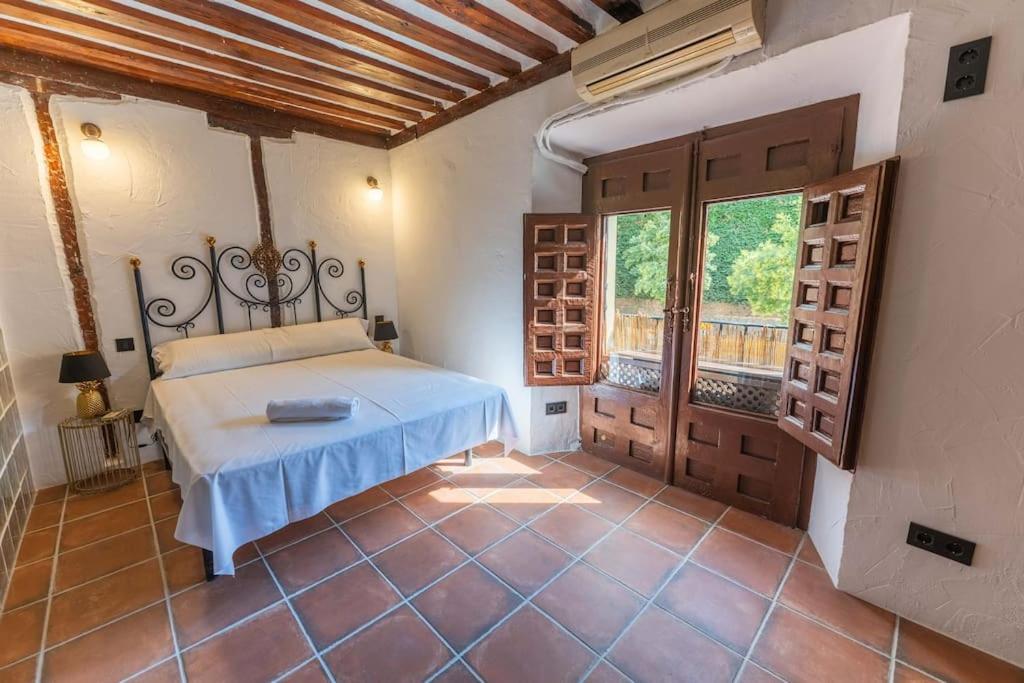 a bedroom with a bed and a large window at Encantador apartamento en Calle Segovia in Madrid