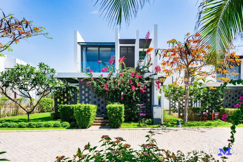 a house with flowers and plants in front of it at Oceanami Sea View Villa - Long Hai Vung Tau in Vung Tau