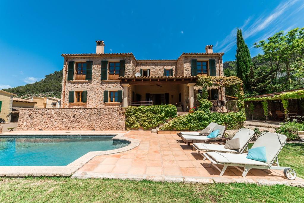 eine Außenansicht eines Hauses mit Pool in der Unterkunft Cas Galgo luxury Villa in Valldemossa in Valldemossa