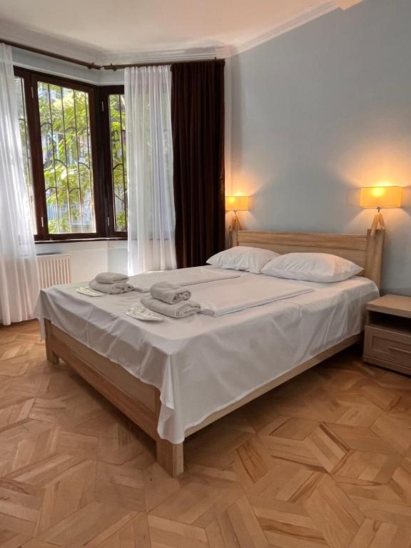 - une chambre avec un grand lit blanc dans l'établissement Vera City Center Apartment, à Tbilissi