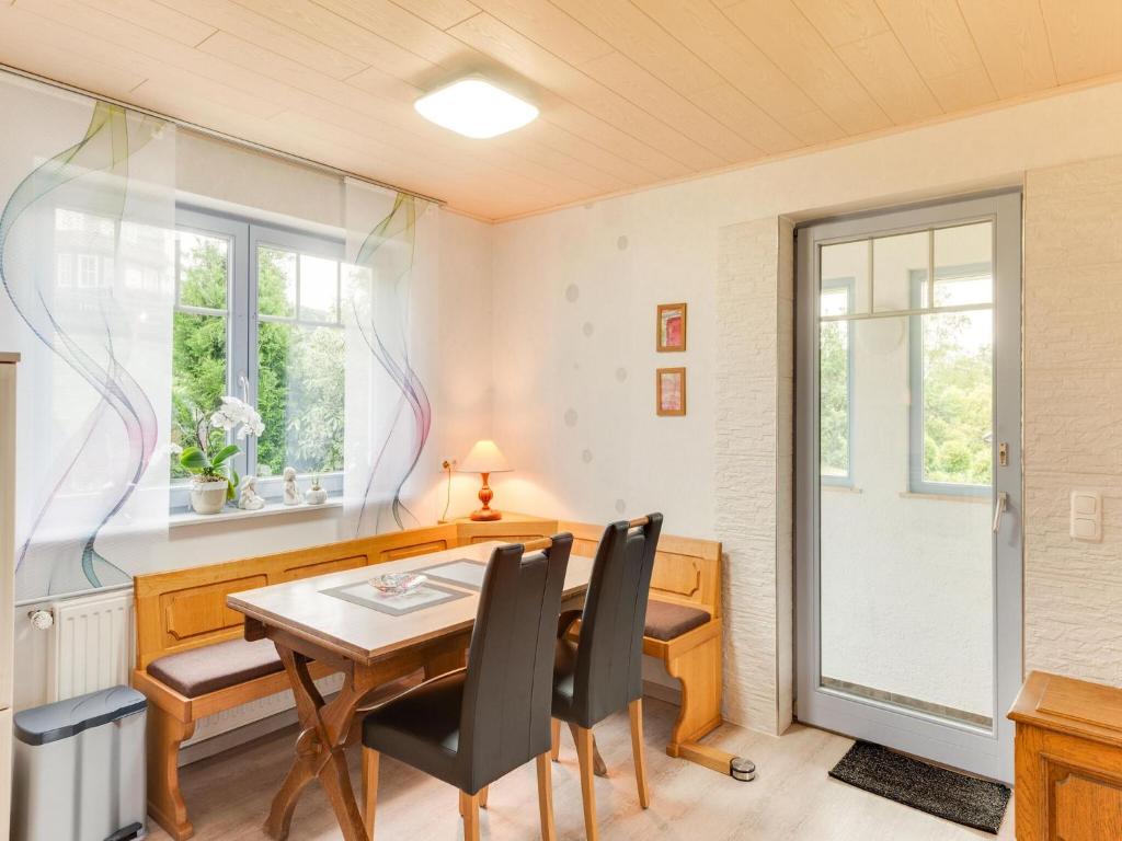 a dining room with a table and chairs and a window at Apartment between Winterberg and Willingen in Medebach